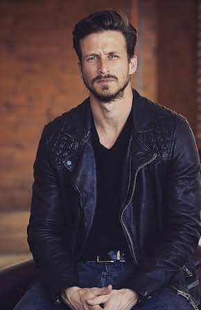 Adam Huber as 