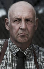 Nick Searcy como 