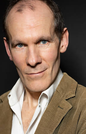 Simon Paisley Day as 