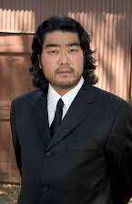 Kurando Mitsutake as Director