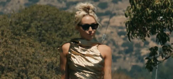 Miley Cyrus racks up millions of views on her 'Flowers' music video.