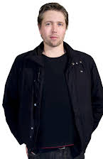 Taki Oldham som Director