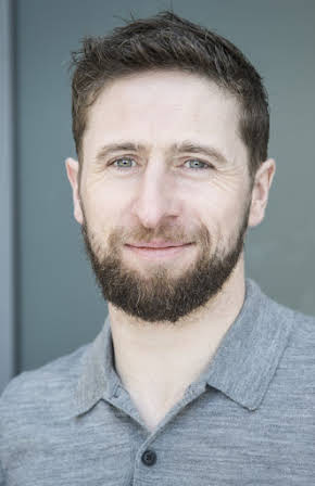 Aaron Monaghan as 