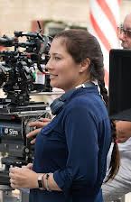 Lesley Demetriades som Director