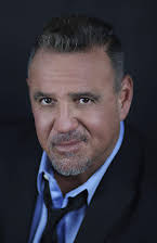 Chris Cardona som Macho Corp. Executive