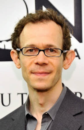 Adam Godley as 