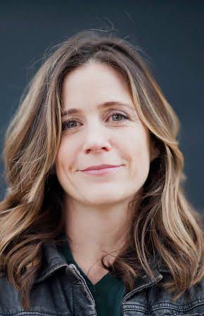 Tracy Droz Tragos as Director