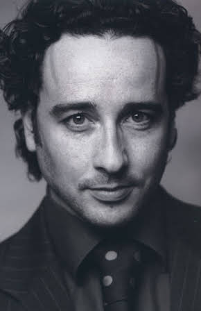 Aidan McArdle as 