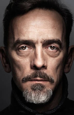 Adrian Schiller as 