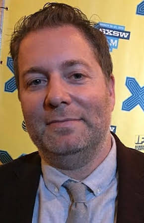 Jay Larson as 