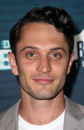 Colin Woodell as 