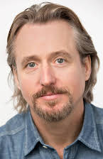 Linus Roache as 