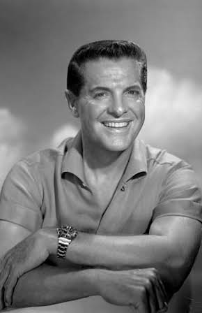 Robert Cummings as 