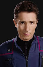 Dominic Keating as 