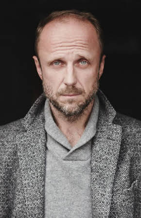 Łukasz Simlat as 