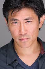 Jinn S. Kim as Man on Fire Escape