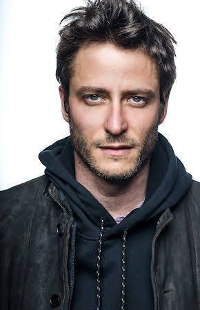 Michael Aloni as 