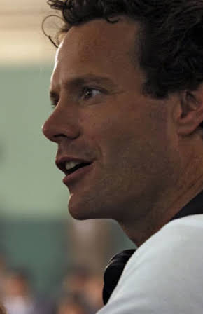 Alex Holmes as Director