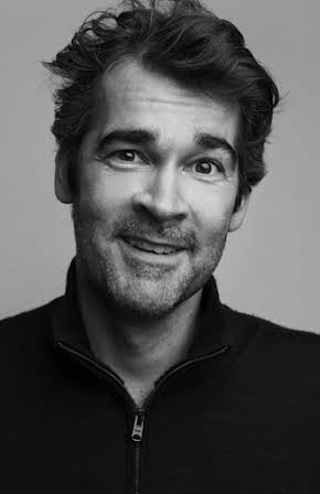 Adam Riches as 
