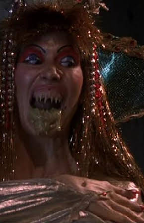 Tanya Papanicolas as Desert Siren No. 2 /  
            Human Hocker /  
            Woman Driver