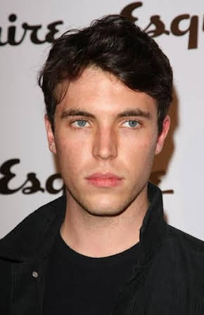 Tom Hughes as 